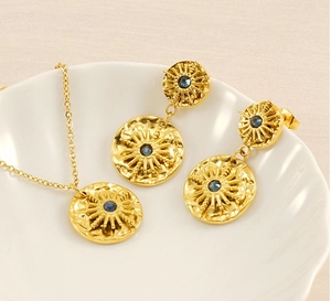Détails d'une parure collier et boucles d'oreilles dorées avec pierres bleues foncées