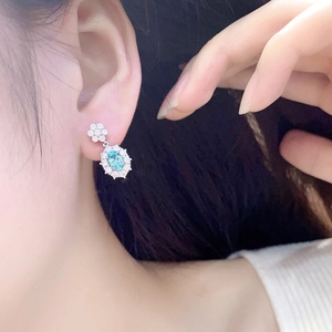 Elegant 925 silver drop earrings featuring light blue oval gems and floral diamond accents