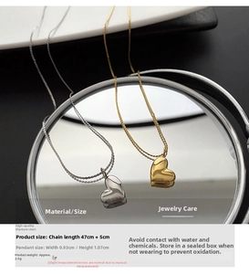 Detailed view of gold and silver titanium steel heart necklaces with size dimensions