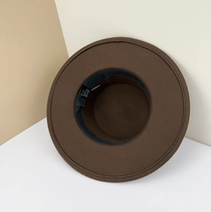 Detail of a brown wool fedora hat featuring a size 57 label and 100% polyester fabric