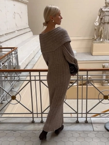 Detail of off-shoulder knitted maxi dress with vertical ribbed texture and long sleeves