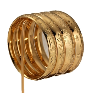 Set of four gold-plated stainless steel wide bangles with intricate floral patterns