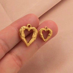 Golden hollow heart wing pendants in two sizes shown on a soft pink background