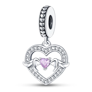 Detail of silver heart charm with pink gemstone and wings, set with sparkling zircons