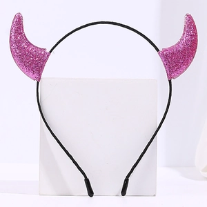 Detailed view of a pink glittery devil horn headband for Halloween costumes
