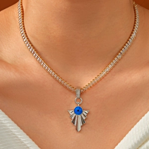 Iced out gold tennis chain with blue evil eye pendant and micro-paved zircons