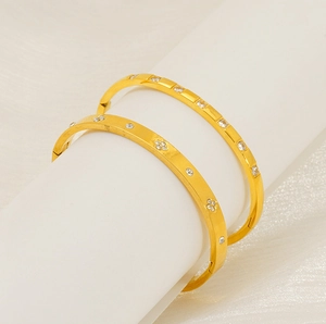 Detail of 18k gold plated stainless steel bangles with sparkling zircon inlay details