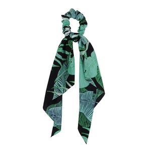 Detail of green and black tropical leaf print scrunchie with long fabric ribbons