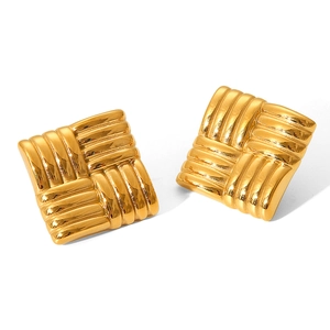 Macro shot of gold plated square stud earrings with textured woven metal surface finish