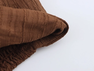 Detailed macro view of the brown knitted fabric texture and ribbed vertical patterns
