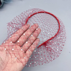 Close-up of red mesh bridal headband with sparkling rhinestones for party accessories