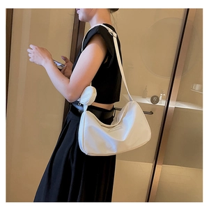 Detail of white nylon crescent bag with mini round coin purse and Fashion label patch