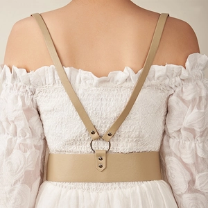 Rear view of khaki leather harness waist belt with metal rings and Y-shaped strap structure
