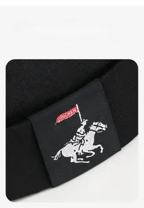 Macro detail of twill fabric texture and embroidered knight rider patch on black docker hat