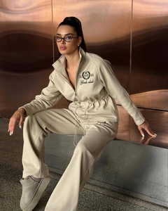Detail of cream drawstring hoodie and pants set with EST 2014 embroidery