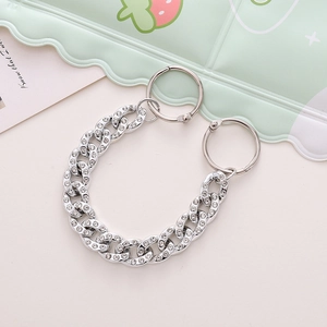 Close-up of silver rhinestone Cuban chain shoe charms with round spring clasps