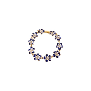 French vintage gold bracelet featuring blue and white enamel floral pattern charms