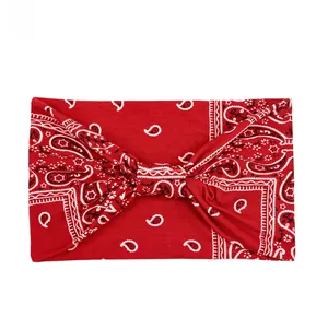 Macro detail of red paisley knot headband with high-elasticity knitted texture