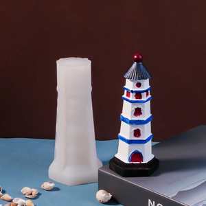 Lighthouse silicone mold with finished DIY Mediterranean lighthouse craft on seaside background
