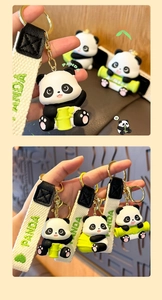 Close-up of resin panda keychain with braided wrist strap and golden metal clasp