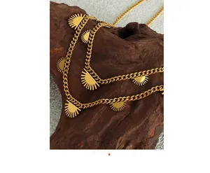 Detail of 18K gold titanium steel necklace with sun pendant on dark wood block