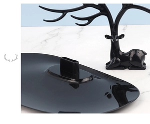 Close-up of black antler jewelry stand components with deer shaped bracket and base tray