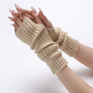 Detail of beige ribbed knit arm warmer showing textured fabric and thumb hole design