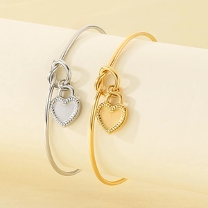 Minimalist stainless steel knot bracelets with heart pendants in gold and silver finish