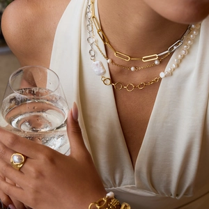 Layered gold chain necklace with baroque pearl pendants and matching bracelet set