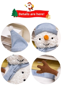 Close-up of plush snowman doll details with blue knit scarf and carrot nose