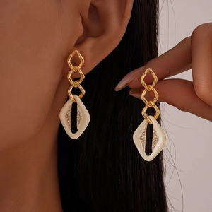 Boucles d'oreilles géométriques dorées avec émail blanc et cristaux brillants pour femme