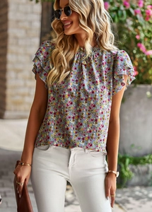 Detail of blue floral print top with ruffle sleeves and small stand collar on a model