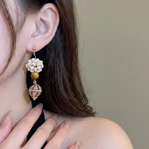 Vintage dangle earrings with tiger eye stones and wooden beads on female model