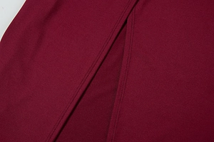 Detail of burgundy summer dress showing high side slit and durable double stitching