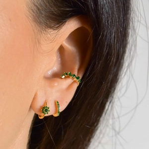Detailed view of s925 gold-plated flower earrings with green zircon on the ear
