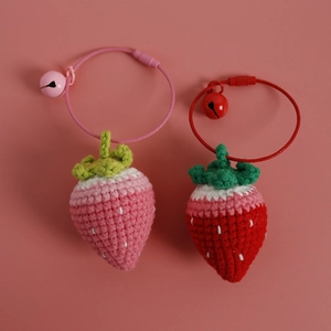 Handmade crochet strawberry charms in red and pink with bells and metal rings