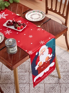 Detail view of linen Christmas table runner with Santa Claus pattern and seasonal text
