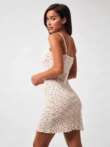Detailed view of floral slip dress showing the ruffled hem and ribbed fabric texture