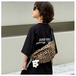 Detailed shot of a stylish leopard print kids waist bag with a cute plush bear pendant