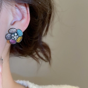 Close-up of a model wearing colorful flower stud earrings with sparkling micro-set zircons