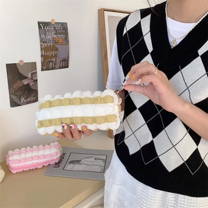 Close-up of fluffy bubble textured stripe pencil case in yellow and pink fabric