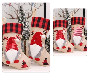 Detail of Christmas stocking featuring gnome embroidery and red black plaid patterns