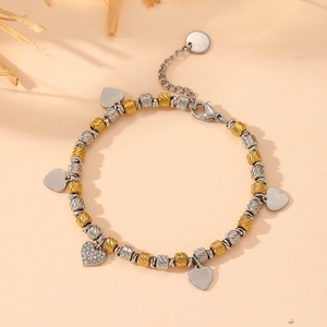 Two-tone gold and silver stainless steel beaded bracelet with heart charms and crystals