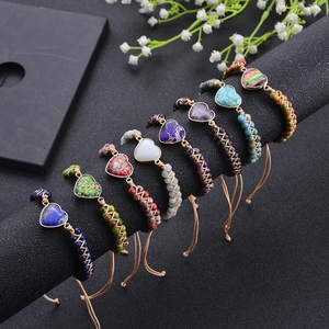 Handmade bohemian heart natural stone bracelets in 8 colors displayed on a black stand