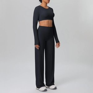 Side view of black long sleeve cropped top and high waist wide leg yoga pants set