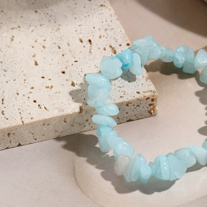 Macro detail of natural blue stone chips on a travertine stone for Bohemian style bracelet
