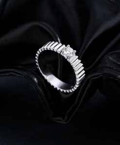 Detailed shot of S925 silver ring featuring a textured corrugated band and a round moissanite