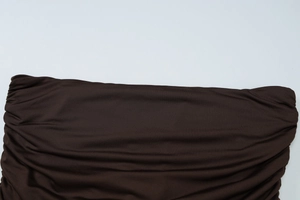 Detailed macro view of dark brown ruched fabric showing high-elasticity texture