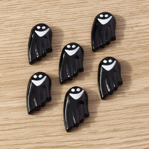 Detail of 6 black cartoon ghost resin charms for DIY Halloween crafts on wood background