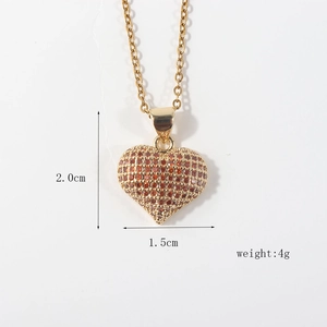 Detailed view of gold plated heart pendant with orange zircon and dimensions 2.0x1.5cm